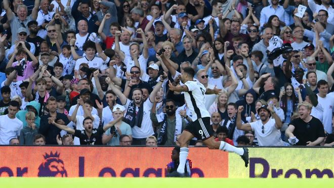 Aleksandar Mitrović celebrates with Fulham fans after scoring his side's first goal against Liverpool