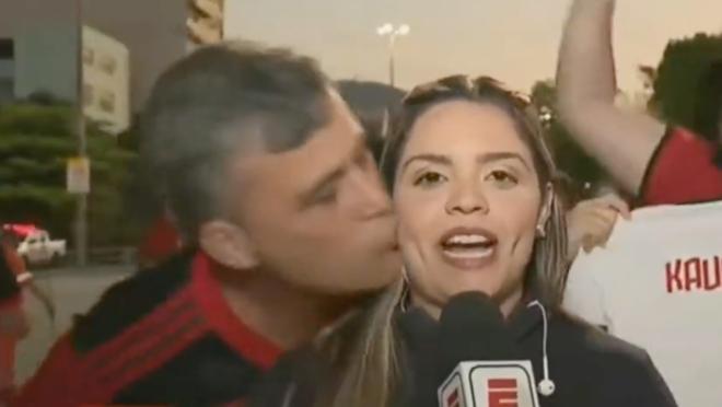 Flamengo fan arrested for kissing reporter on live TV.
