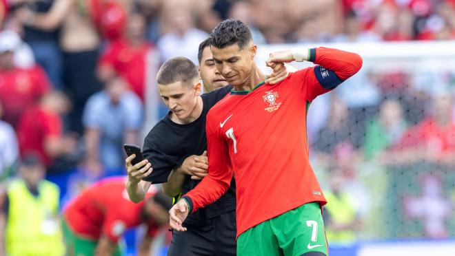 A pitch invader takes a selfie photograph with Cristiano Ronaldo during the UEFA Euro 2024 match between Turkiye v Portugal