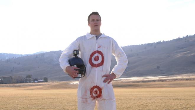 Jack the intern stands holding his helmet ready for action as Target Man