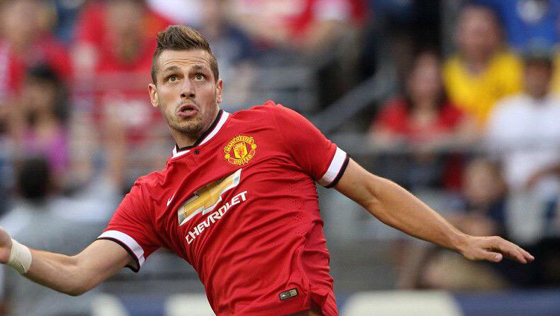 Morgan Schneiderlin is reacting to a ball in the air during a United preseason friendly.